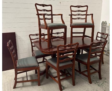 A mahogany dining table with eight ladder back Chippendale style chairs and an extra leaf (159cm x 10cm) (leaf 54cm)