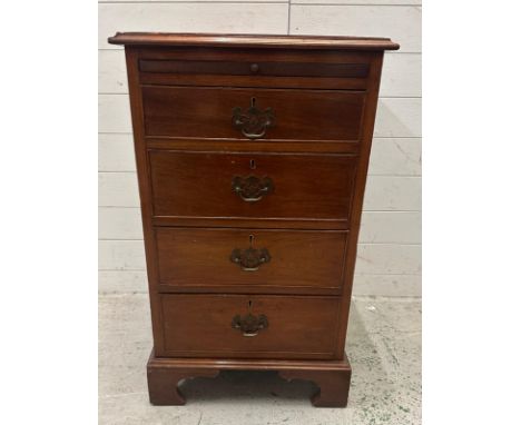 A mahogany unit with  three drawers and pull out shelf on block feet (H86cm W53cm D51cm)