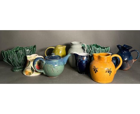 A selection of glazed ceramics in various styles, to include sylvac and some studio pottery jugs 