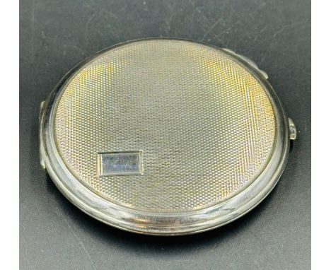 A silver compact with inset mirror by Crisford & Norris Ltd Birmingham 1954