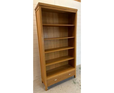 A contemporary four shelf wooden bookcase with one long drawer under (H197cm W100cm D35cm)