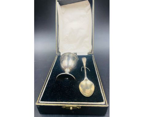 A hallmarked silver Christening set of egg cup and spoon by Robert Pringle & Sons Birmingham 1928, cased.