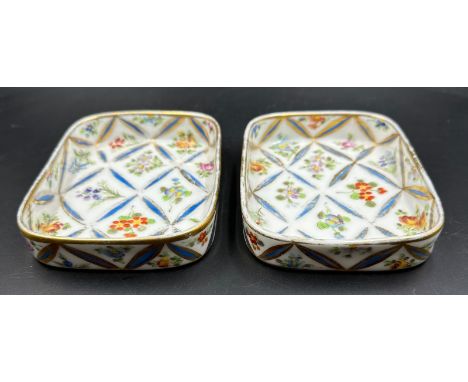 Two oblong china trinket dishes by Delvaux of Paris. Gilt rims with a foliate pattern