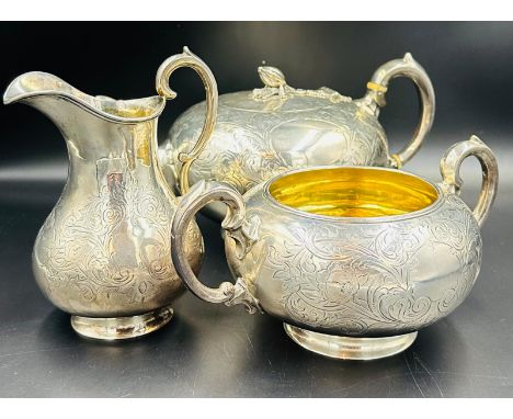 A Victorian three piece silver tea service to include teapot with acorn finial, sugar bowl and milk jug, hallmarked for Londo