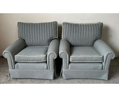 A three seater sofa and two matching arm chairs upholstered in blue with white piping and striped back cushion