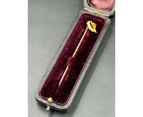 A seed pearl and ruby lapel pin on untested gold, cased.