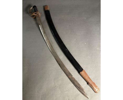 An ornamental Indian sabre in scabbard. The blade etched with a scrolling foliate pattern