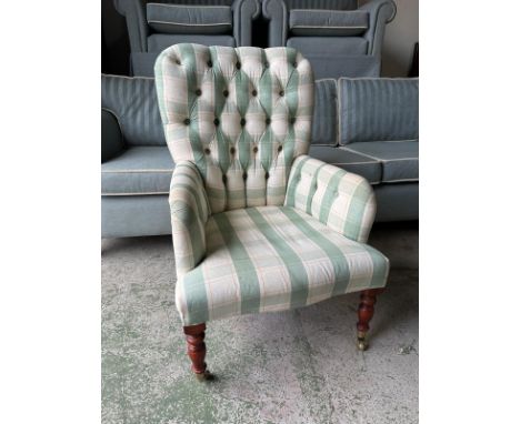 A green and white checked button back bedroom chair 
