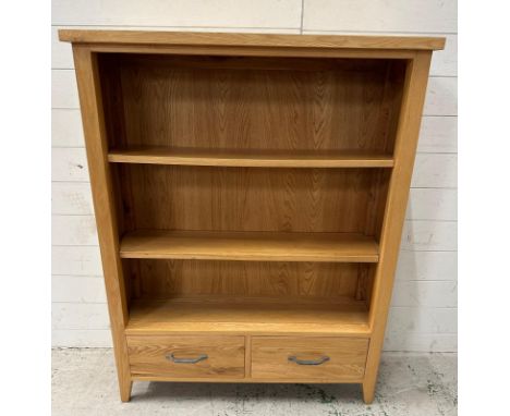 A contemporary light oak two shelf bookcase with two drawers under (H120cm W94cm D27cm)