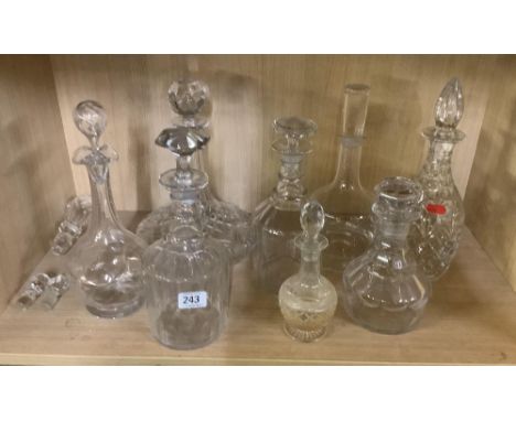 SHELF OF GLASS DECANTERS &amp; STOPPERS