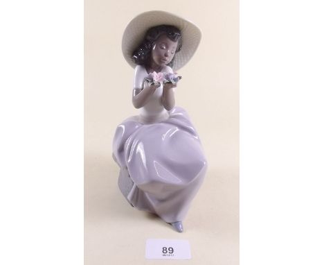 A Lladro figure of a seated girl holding flowers - boxed 'Sweet Fragrance'