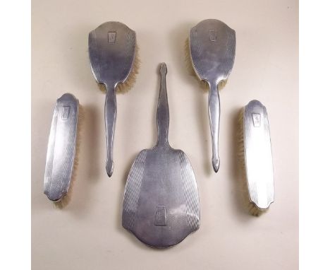 A five piece silver brush and mirror set