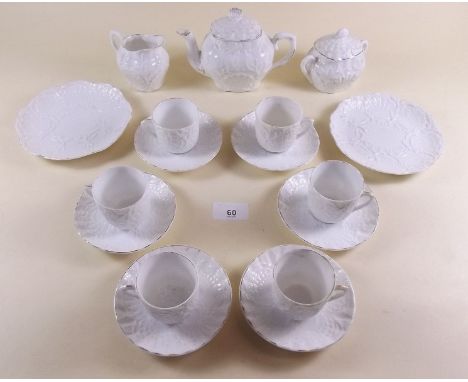 A Victorian white porcelain dolls tea service comprising: 6 cups and saucers teapot, sugar bowl, milk jug and 2 cake plates.