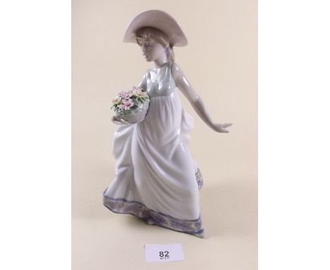 A Lladro figure of a girl with flowers - boxed 'Carefree'