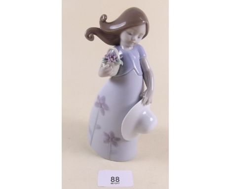 A Lladro figure of a girl holding a hat and flowers - boxed 'Little Violet'