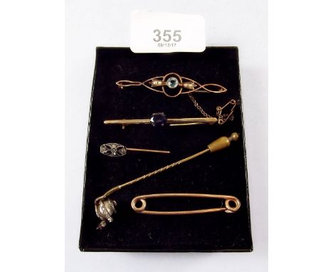 An early 20th century snakeshead stick pin, a paste stick pin and three bar brooches