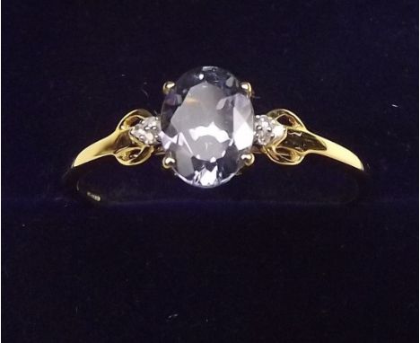 A 9K gold tanzanite ring on diamond set shoulders, size T