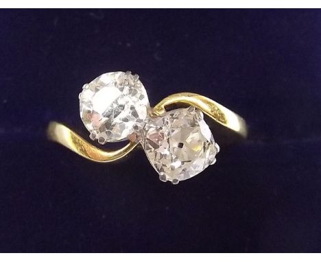 A fine 18 carat gold and platinum set large diamond crossover ring - each stone approx. one carat, size N