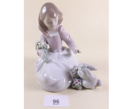 A Lladro figure of a seated girl with rabbit - boxed 'Forest Encounter'