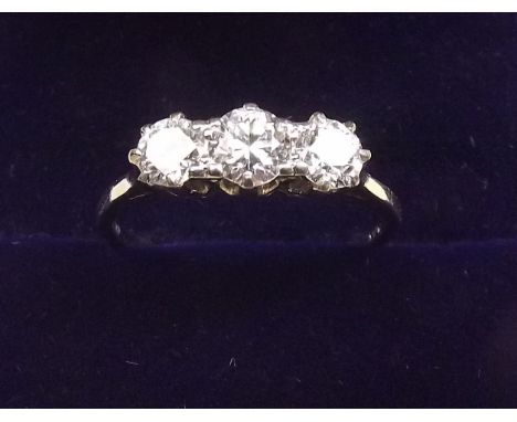 A platinum set three stone diamond ring, size M