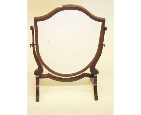 A shield form mahogany swing toiletry mirror