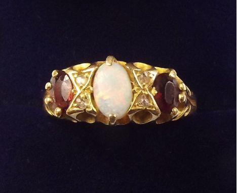 An 18 carat gold opal, garnet and diamond set ring, size P