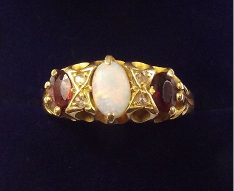 An 18 carat gold opal, garnet and diamond set ring, size P