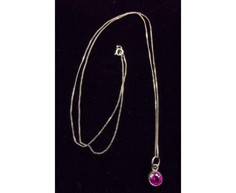 A 9 carat gold pendant set ruby on 9 carat gold chain
