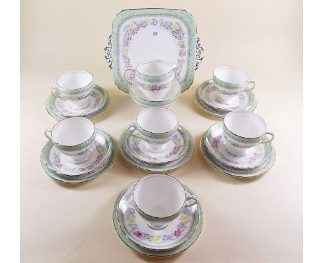 A Foley floral tea service comprising six cups and saucers, six tea plates, cake plate, milk and sugar