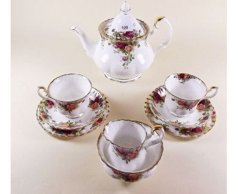 A Royal Albert tea service comprising: teapot, six cups and saucers, two jugs, six tea plates and cake plate