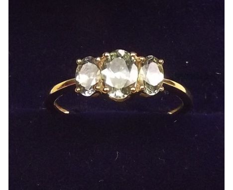 A 9K gold green tanzanite three stone ring, size O and a half