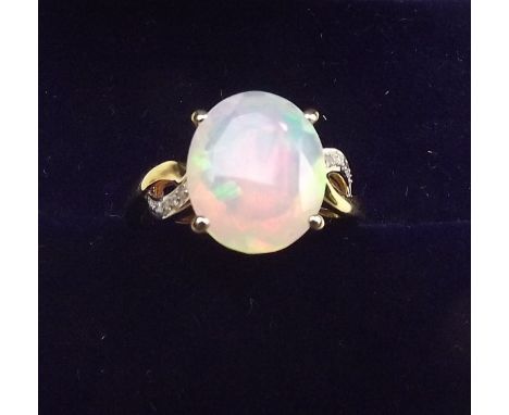 A 9K gold Ethiopian opal ring on diamond set shoulders, size L