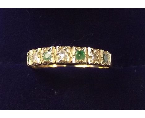 A 9 carat gold emerald and chip diamond set ring - size M