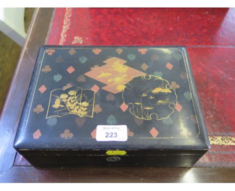 An early 20th century lacquered playing card gaming box depicting the suits and Chinese motifs, containing compartments, play