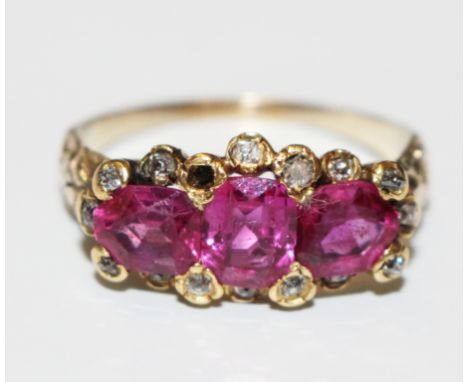 A three stone ruby and diamond ring, one small diamond missing (this ring carries a laboratory certificate for natural coruad