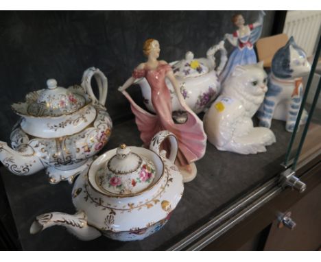 A Fenton floral design teapot, a Victorian floral decorated teapot, a Hammersley Victorian Violets teapot, a Royal Doulton fi