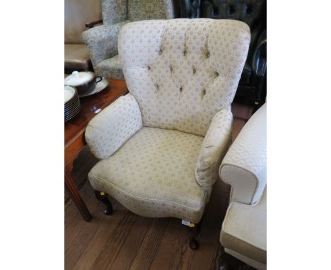 A Victorian style button upholstered armchair with cabriole legs