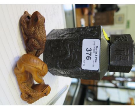 Two carved hardwood netsuke in the form of frogs, modern, each 6cm wide and a bronzed metal octagonal Chinese style tea caddy