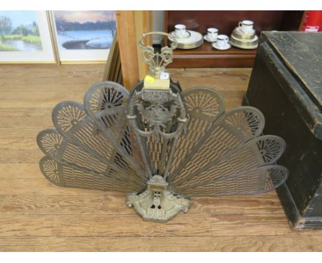 A Victorian brass fan shape folding firescreen, the central support cast with profile masks, swags and husks, 67cm high