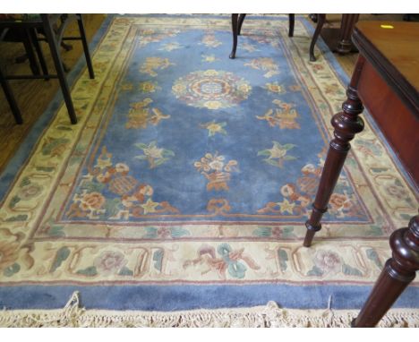 A Chinese carpet, the floral motif on a blue ground and ivory border, 304cm x 180cm