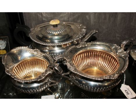 A three piece silver tea set on single foot by Elkington & Co, having fluted decoration and gilded interior to sugar basin an