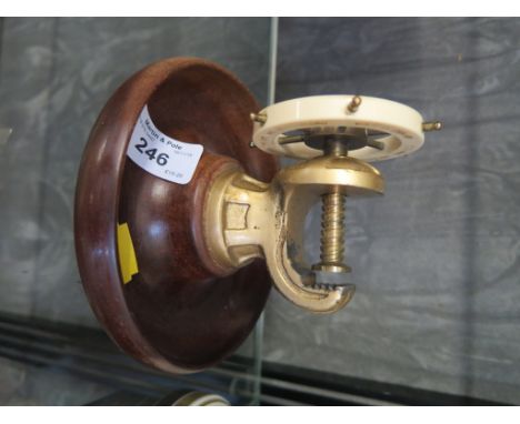 A vintage ships wheel nut cracker with brass fittings and mahogany bowl