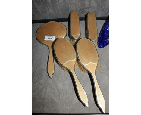 A five piece silver mirror and brush set decorated in yellow enamel