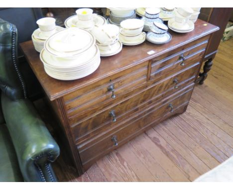 An Edwardian oak chest of two short and two long drawers on bracket feet, 107cm wide