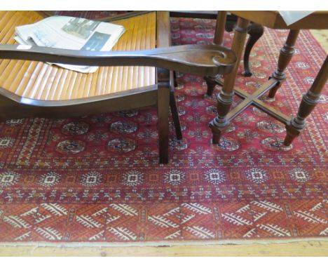 A Bokhara carpet, the five rows of guls on a red field with multiple border, 274cms x 193cms