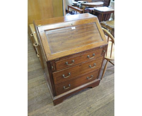 An Edwardian mahogany and satinwood crossbanded bureau, the panelled slope over three graduated drawers on bracket feet, 69cm