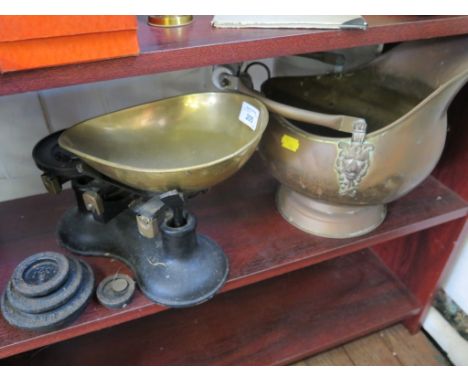 A brass helmet shaped coal scuttle and a set of kitchen scales (2)
