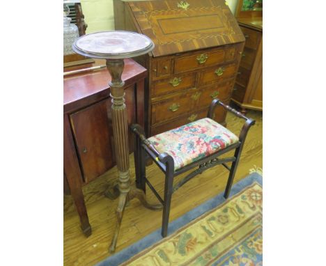 A mahogany torchere, with circular top, reeded stem and tripod base 108cm high, and an ebonised piano stool