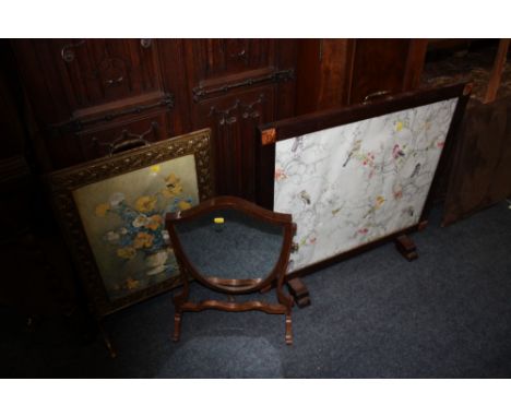 AN OAK FIRESCREEN DEPICTING BIRDS TOGETHER WITH A BRASS FRAMED FIRESCREEN PLUS A SWING MIRROR