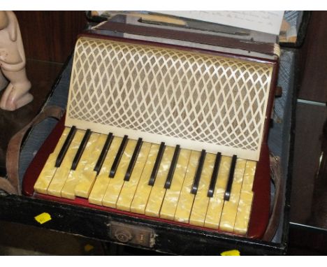 A CASED VINTAGE 32 BUTTON ACCORDION 